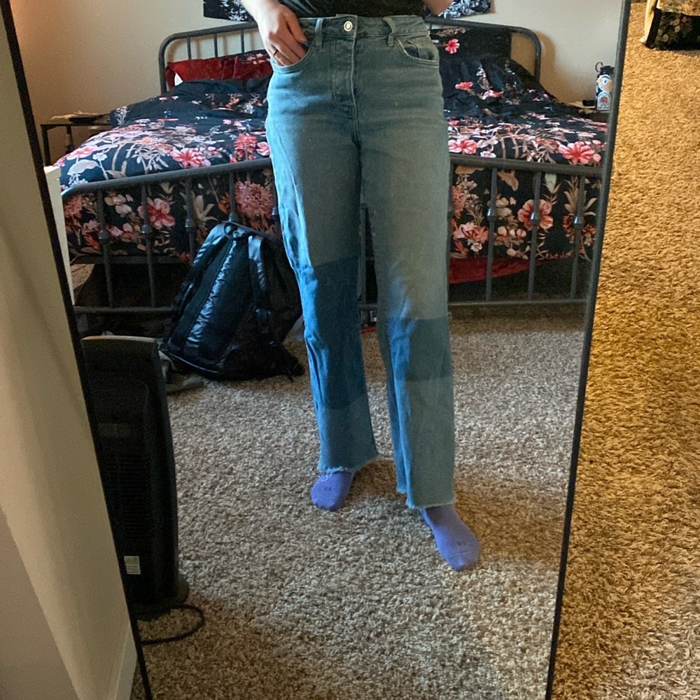 Pair of jeans with color blocking.
